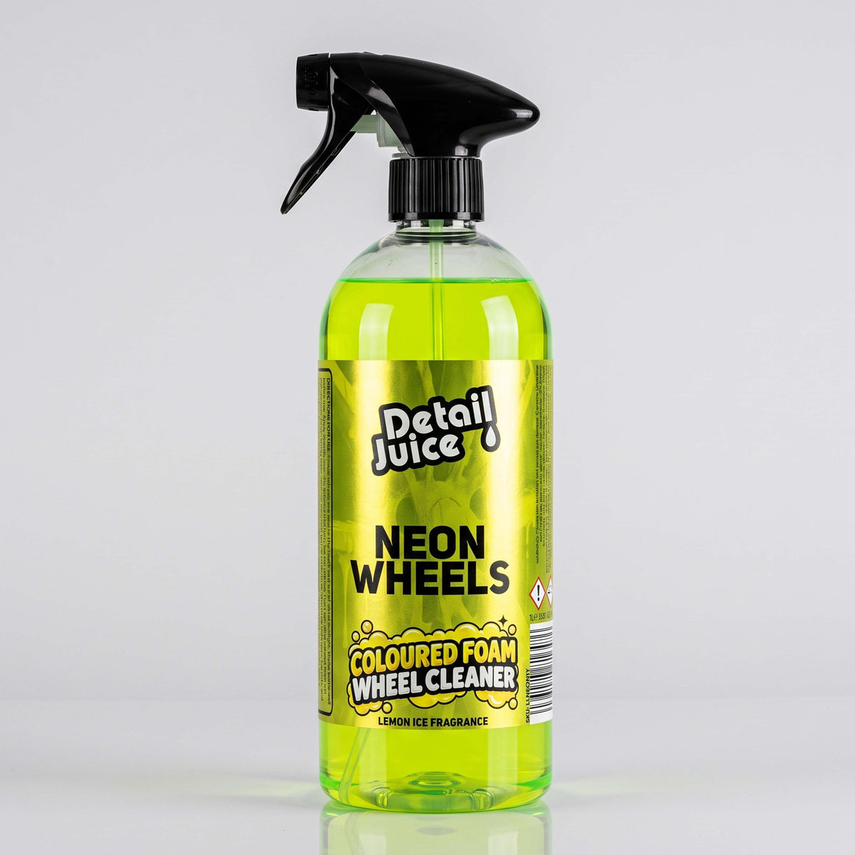 A bottle of Detail Juice Neon Wheels Coloured Foam Wheel Cleaner with bright neon yellow-green liquid inside, a black spray trigger top, and a yellow label, set against a light gray background with a soft reflection.